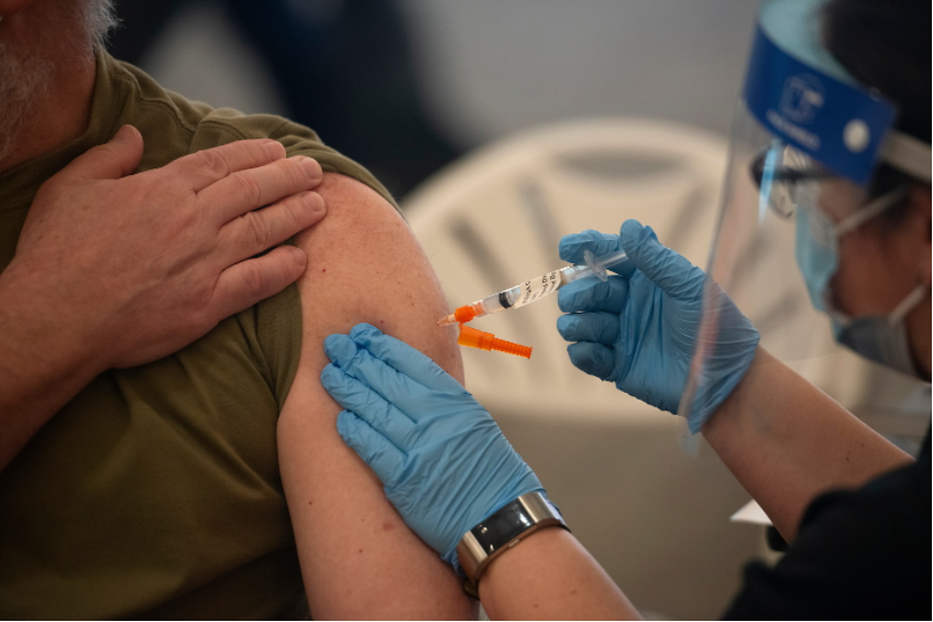 Decorative. Healthcare worker giving someone a vaccine.