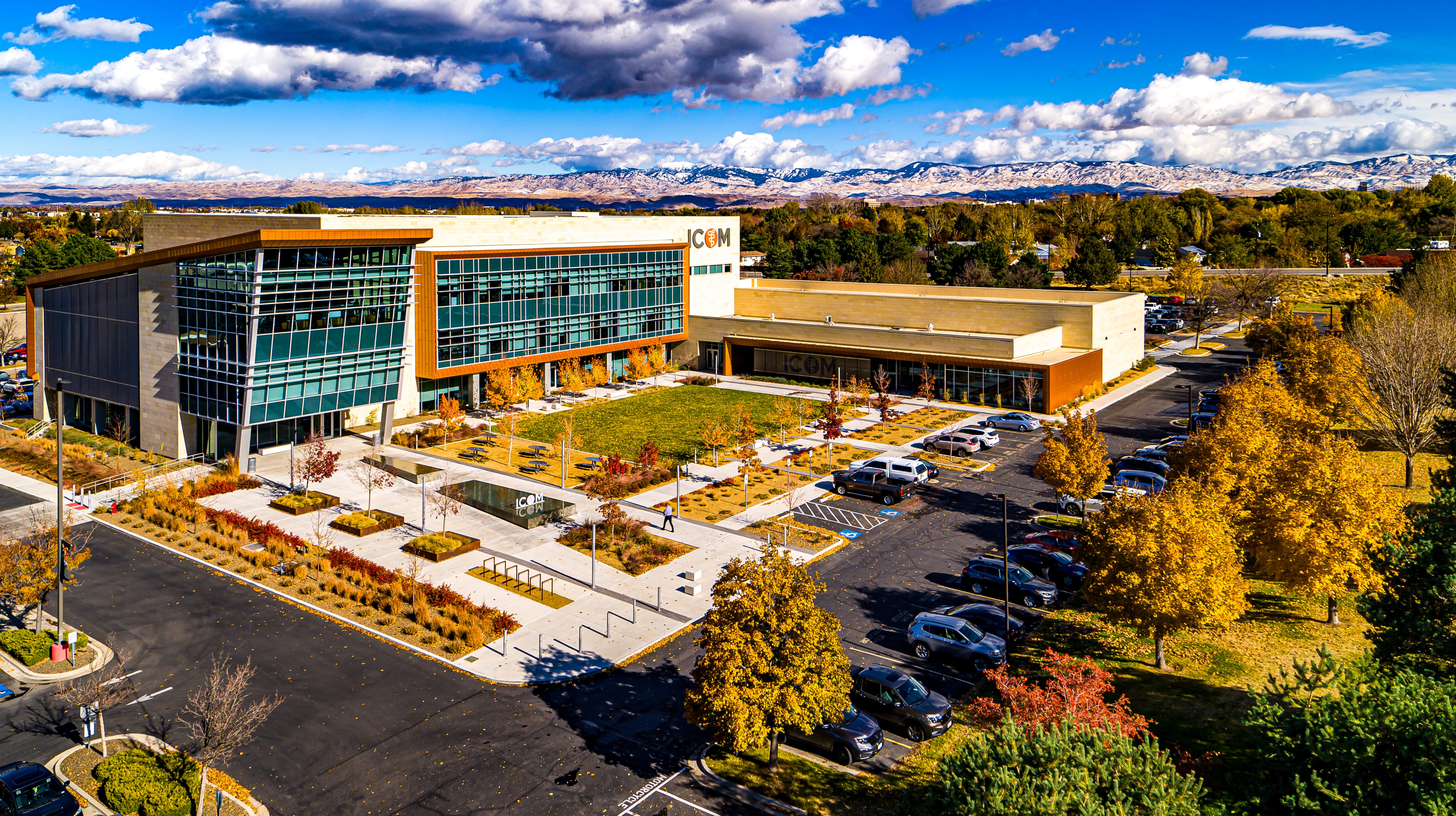Overhead view of ICOM building at the Idaho College of Osteopathic Medicine campus with snowy mountains in the background.