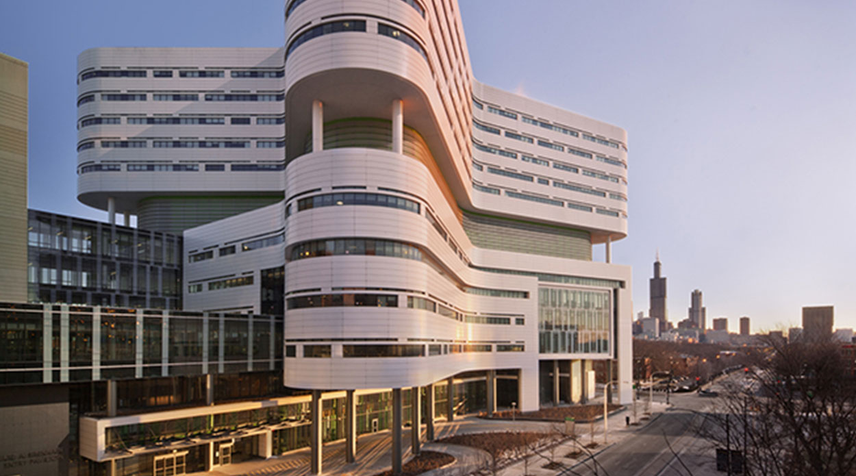 Outside view of a building on RUSH campus with a city skyline in the background.