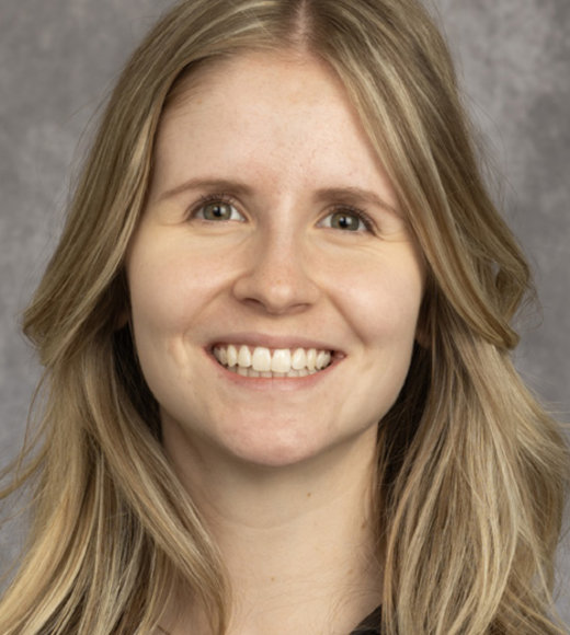 Headshot of blond woman names Elise smiling.
