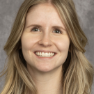 Headshot of blond woman names Elise smiling.